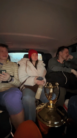 Group celebrates with gold trophy in Moscow car