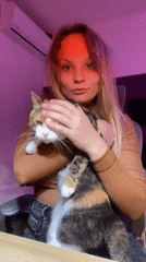 Woman poses with cat during quiet evening in Tel Aviv