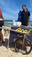 Two men spotted walking on Rio beach during sunny afternoon