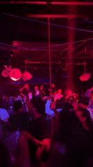 Valencia nightclub bustling with dancers under colorful lights