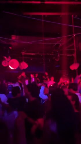 Valencia nightclub bustling with dancers under colorful lights