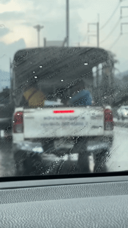 Stuck in rainy Kathu traffic, windshield streaked, sky grey