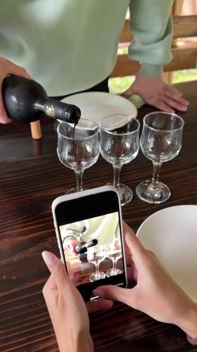 Couple shares wine tasting, selfies by Abkhazia river