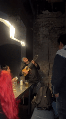 London evening captures street musician performance and nighttime traffic