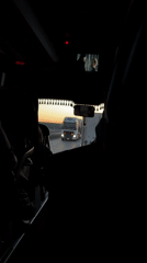 Bus passenger observes highway traffic under dusky Russian skies
