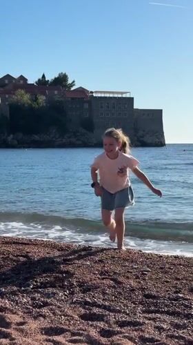 Children and dog enjoy sunny afternoon at Sveti Stefan beach