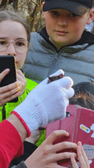 Person in red hoodie addresses crowd in Vinnytsia park