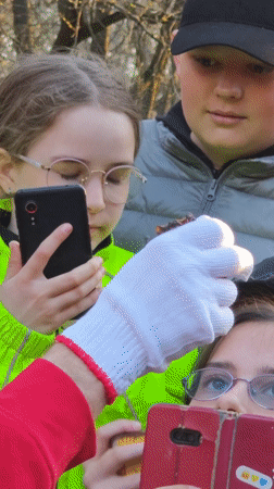 Person in red hoodie addresses crowd in Vinnytsia park