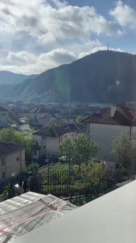 Morning window view captures sunny Zlatograd landscape with mountains