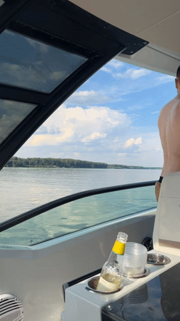 Afternoon boat ride on a calm, tree-lined waterway