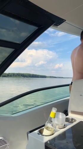 Afternoon boat ride on a calm, tree-lined waterway