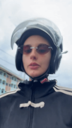 Motorcyclist in black helmet and striped jacket recorded in Wichit