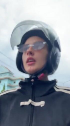 Motorcyclist in black helmet and striped jacket recorded in Wichit