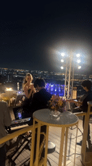 Live rooftop concert performed against Bangkok city skyline