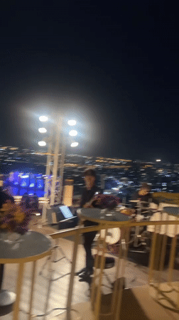 Live rooftop concert performed against Bangkok city skyline