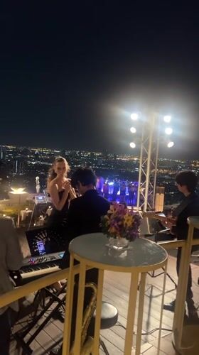 Live rooftop concert performed against Bangkok city skyline