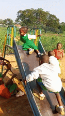 Kids at play on a colorful schoolyard playground in Akwanga