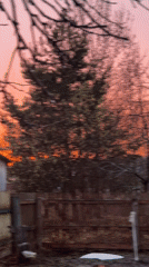 Mother and child enjoy muddy backyard sunset moments