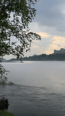 Cyclist pauses for misty morning moment along Yenisei River