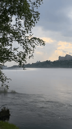 Cyclist pauses for misty morning moment along Yenisei River