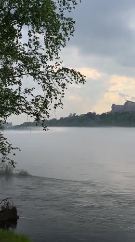Cyclist pauses for misty morning moment along Yenisei River