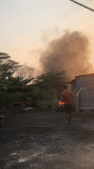 Street market morning in East Java, with a fire in the background