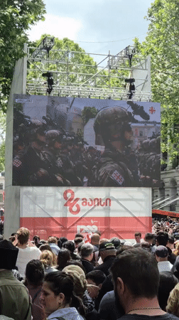 Crowd watches military parade on screens in Tbilisi square