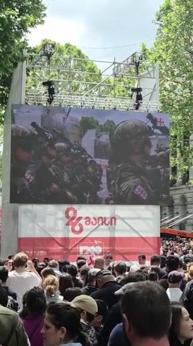 Crowd watches military parade on screens in Tbilisi square