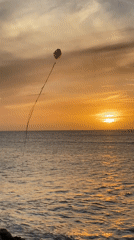 Evening kite flying captured at Juan Griego waterfront sunset