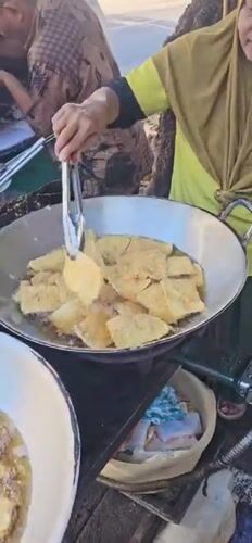 Morning street food preparation captured in Denpasar, Indonesia
