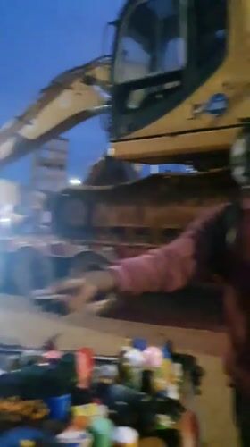 Dirt-covered excavator hauled out of Bukuru at dusk