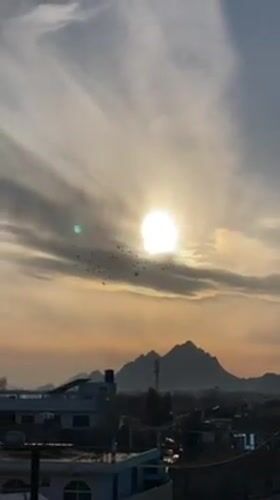 Sunset scenes with birds, children captured across Kandahar cityscape