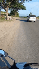 Scooter rider follows white van on Lhokseumawe road