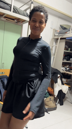 Woman dances in dorm room in Beijing's Daxing District