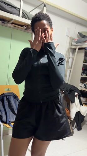 Woman dances in dorm room in Beijing's Daxing District