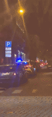Police car with flashing lights stops near tram in Riga
