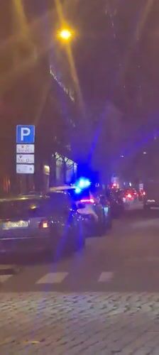Police car with flashing lights stops near tram in Riga