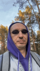 Man in purple hoodie walks through Tallinn streets