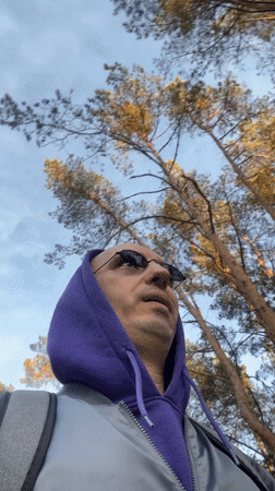Man in purple hoodie walks through Tallinn streets