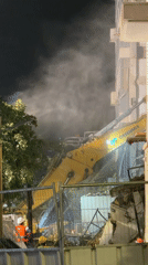 Night demolition operation underway in Tel Aviv with excavator