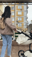 Mother with baby stroller walks covered walkway during rain in Sochi