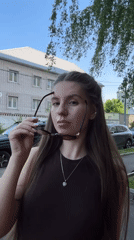 Woman spotted on sunny sidewalk in Klin, Russia