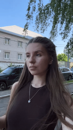 Woman spotted on sunny sidewalk in Klin, Russia