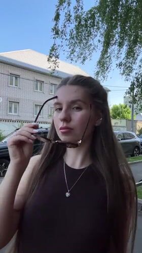Woman spotted on sunny sidewalk in Klin, Russia