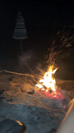 Bonfire and beach umbrella on a Burgas summer night