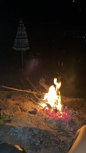 Bonfire and beach umbrella on a Burgas summer night