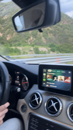 Driver travels highway near Simitli with mountain backdrop
