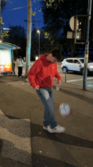 Man juggles soccer ball at bus stop in Rijeka