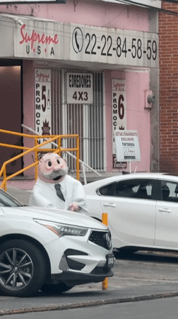 Costumed man with pink head spotted outside Puebla business