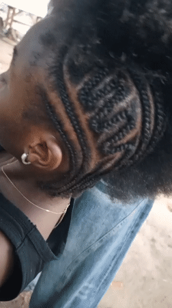 Women share outdoor hair braiding session in Keffi